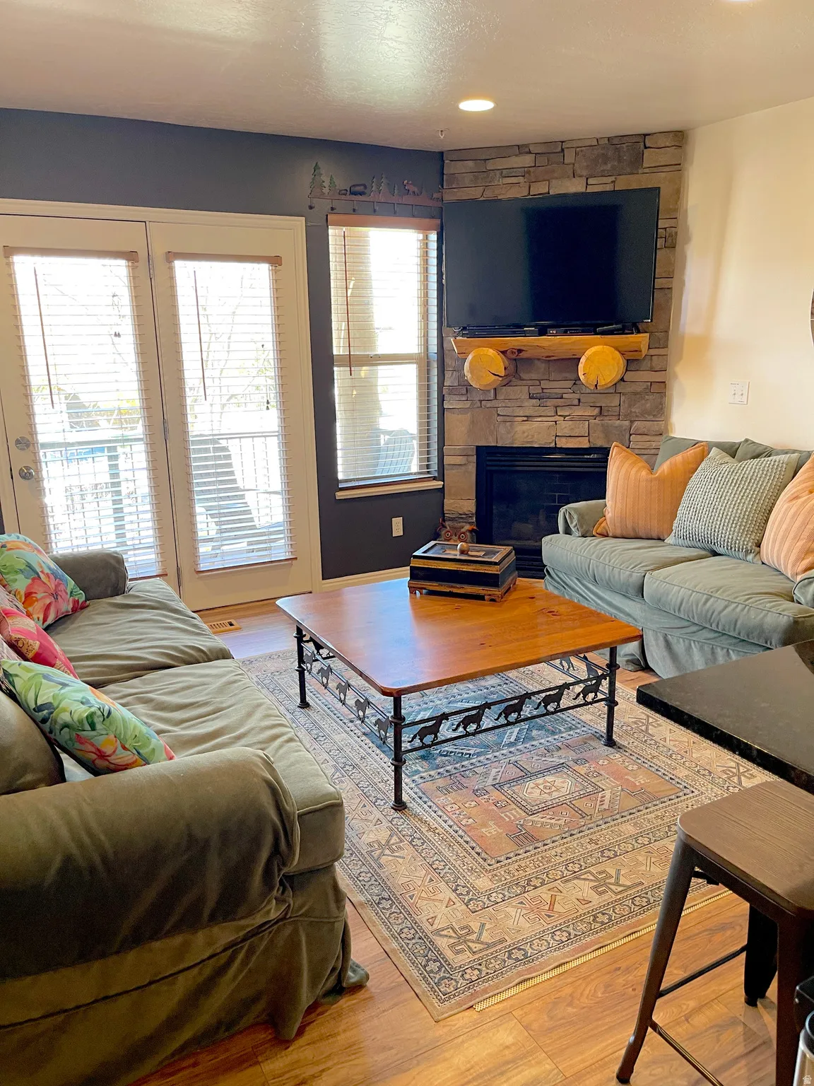 Living area featuring light wood-type flooring, a fireplace, and recessed lighting