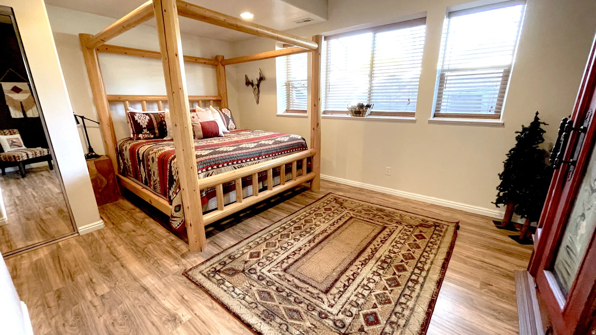 Primary suite with light wood-style floors