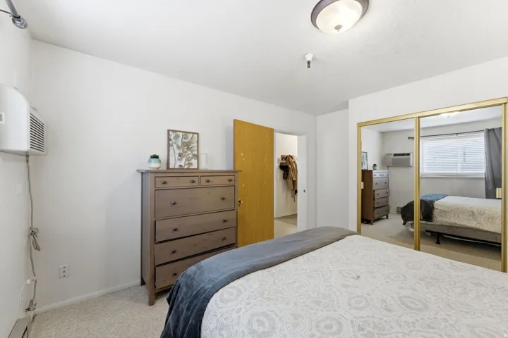 Bedroom featuring light colored carpet and a closet