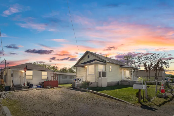 View of front facade featuring a yard and entry steps