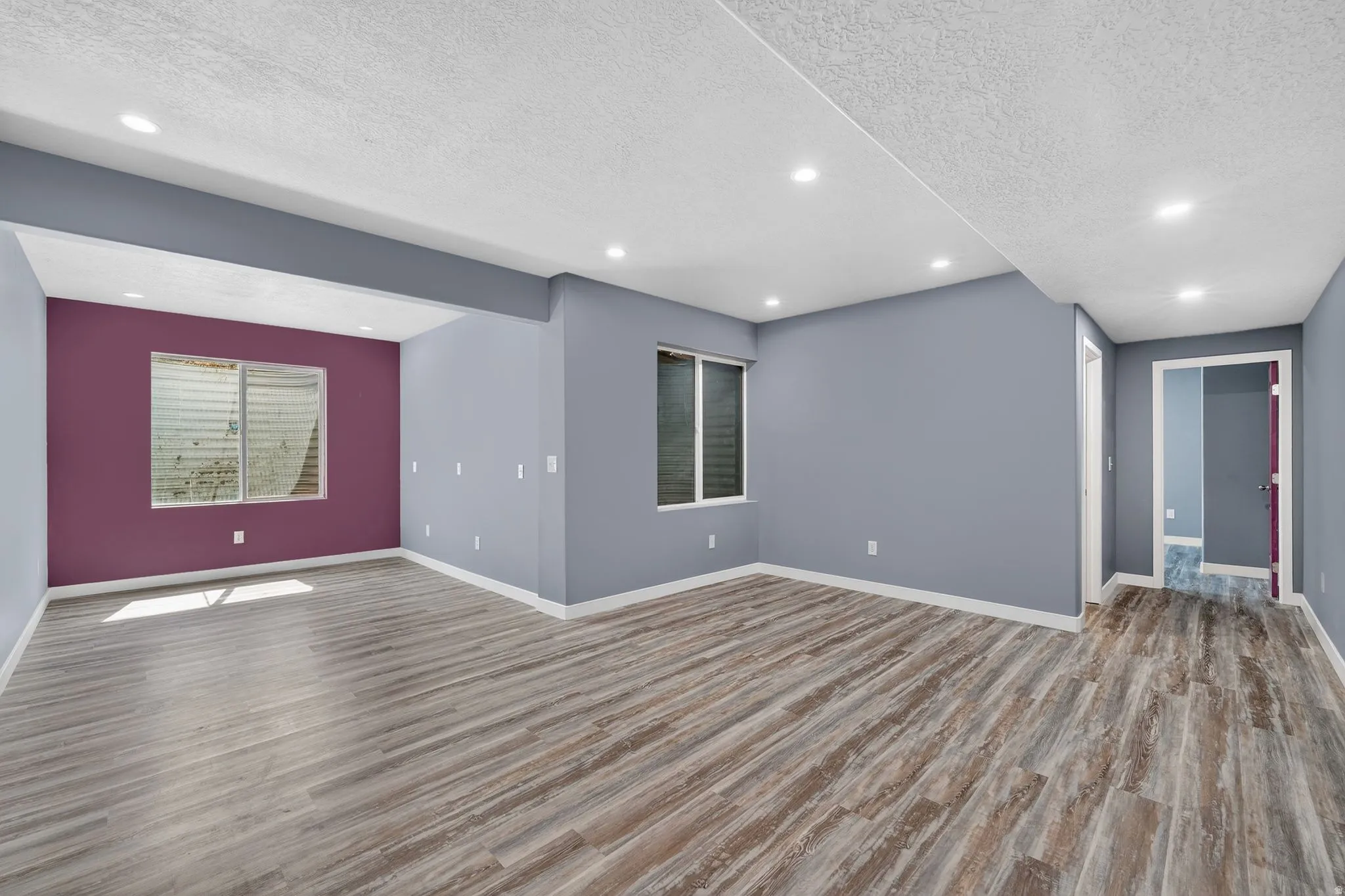 Empty room with recessed lighting, a textured ceiling, and light wood finished floors