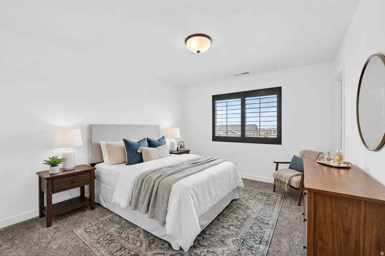 Bedroom featuring dark carpet