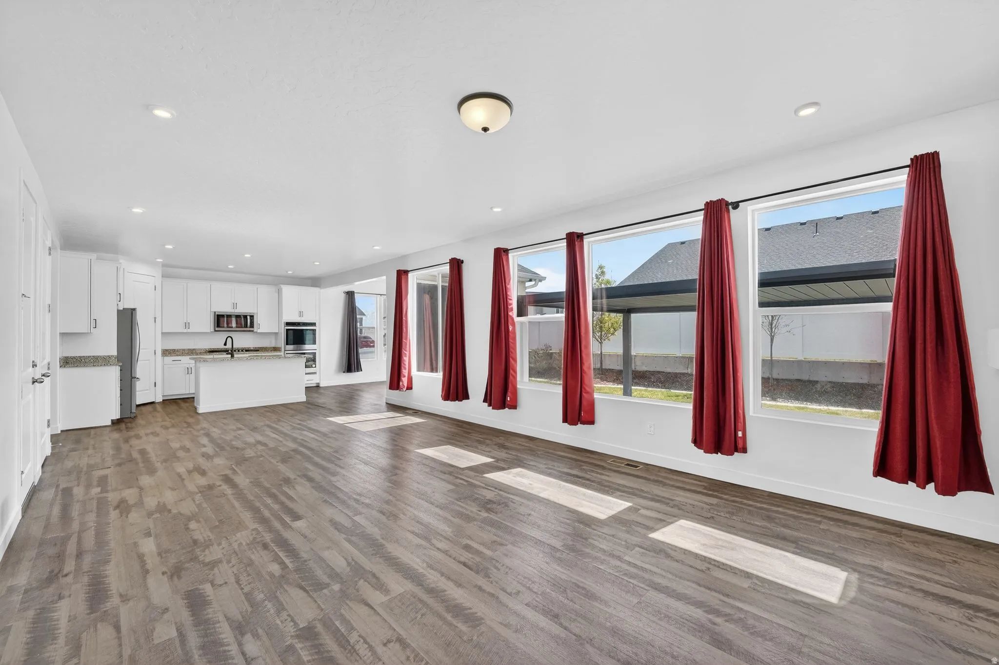 Unfurnished living room with recessed lighting and dark wood finished floors