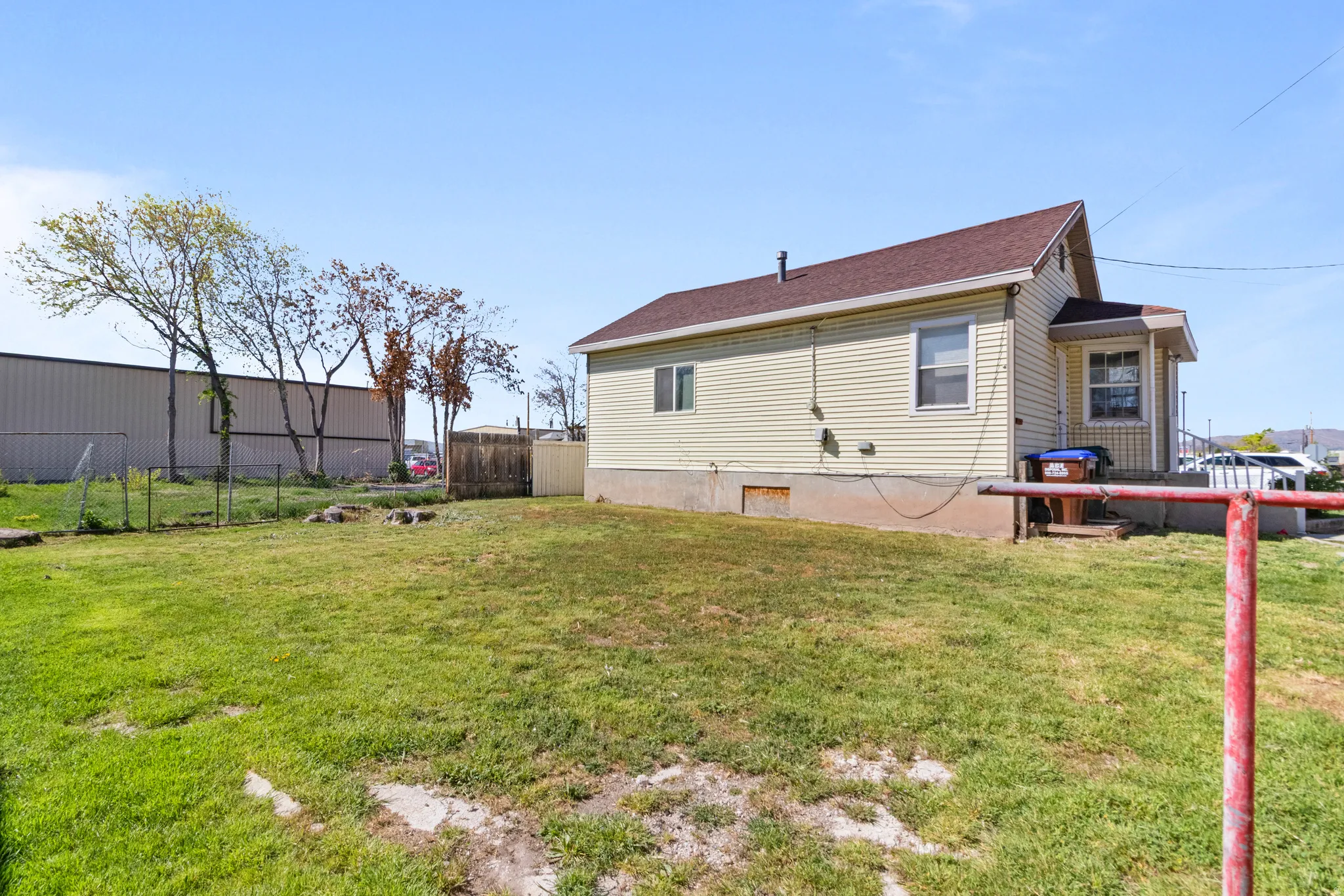 Rear view of property featuring a shingled roof