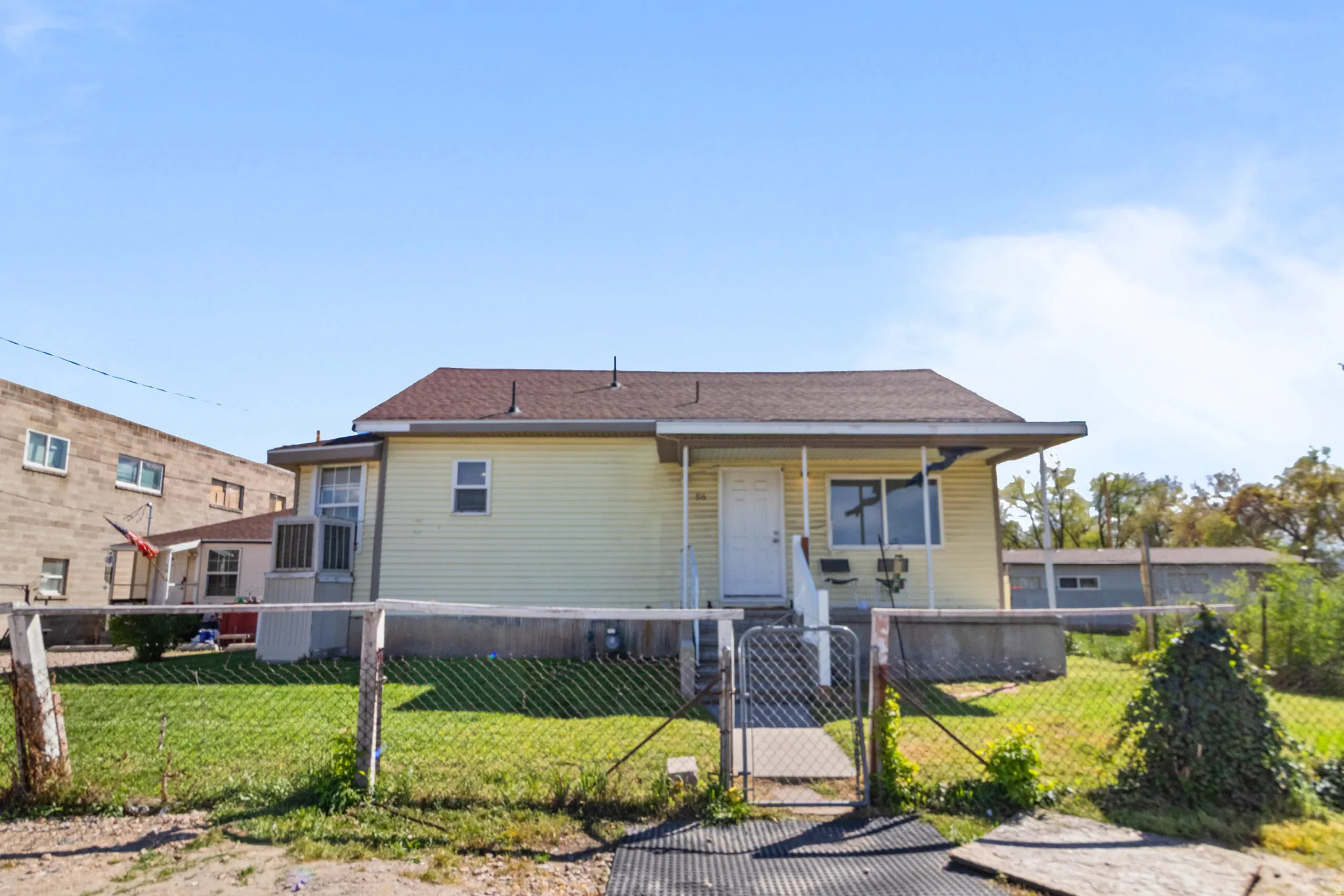 View of front of home with a gate and a fenced front yard
