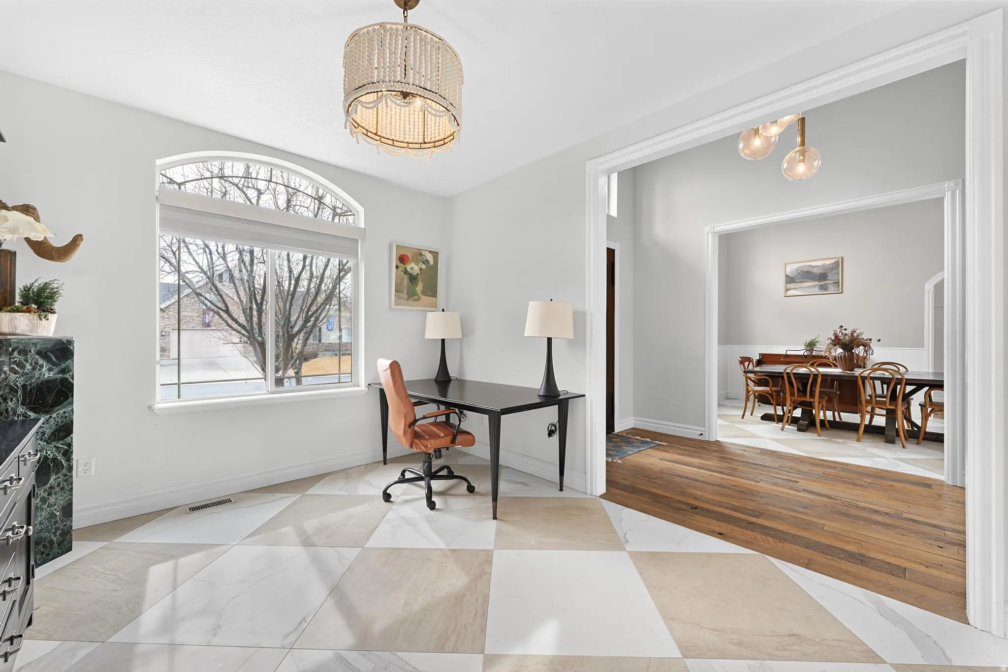 Office with suspended lighting and baseboards