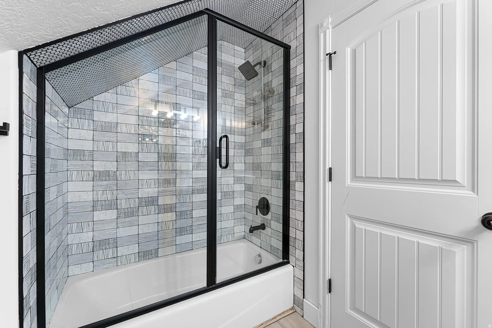 Bathroom featuring enclosed tub / shower combo