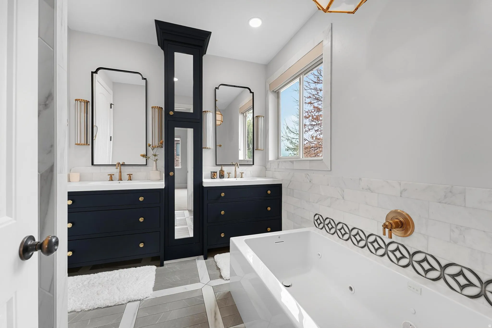 Full bath with two vanities, light tile patterned floors, a whirlpool tub, tile walls, and recessed lighting