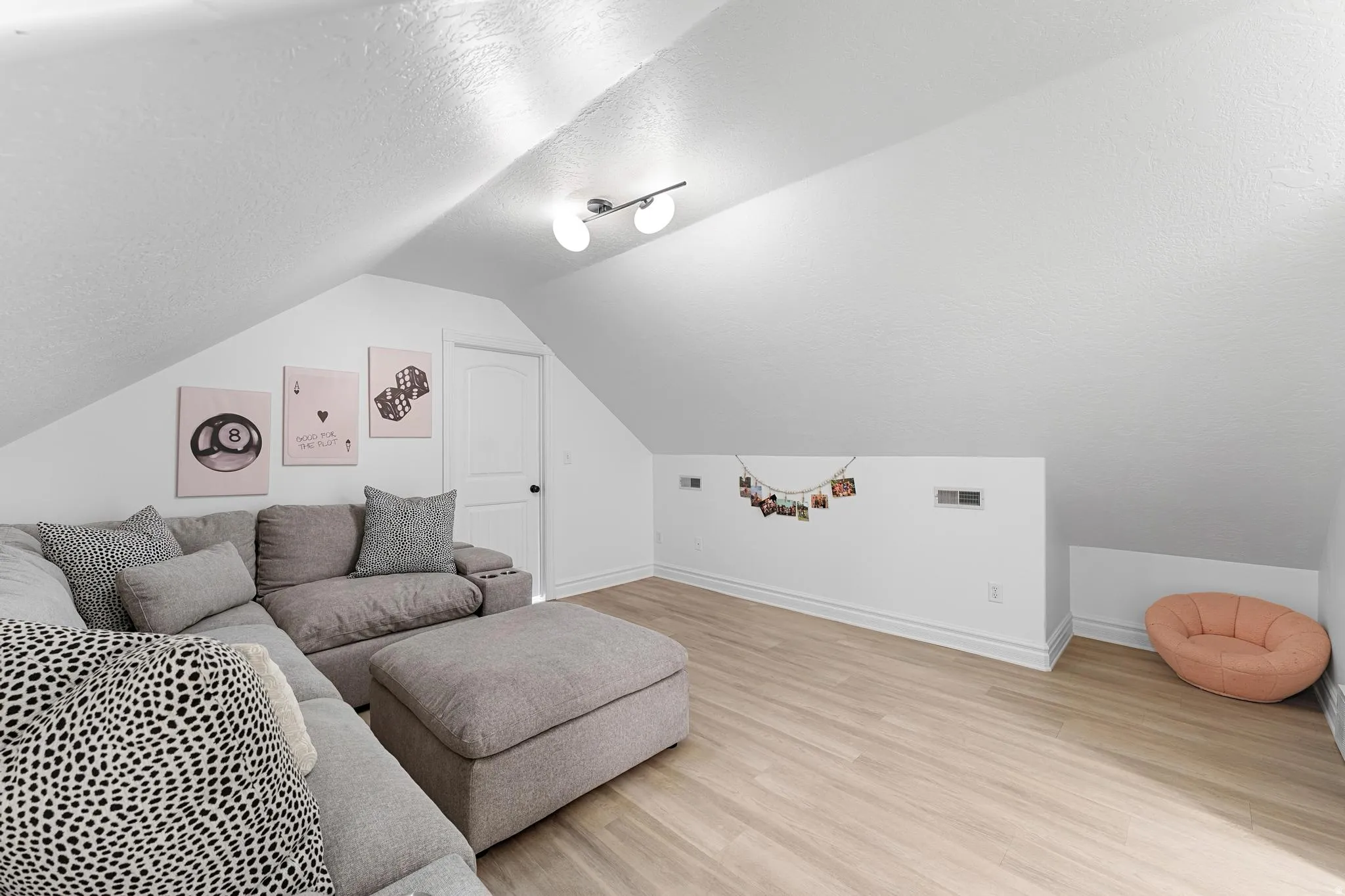 Living room featuring light wood-style flooring and a textured ceiling