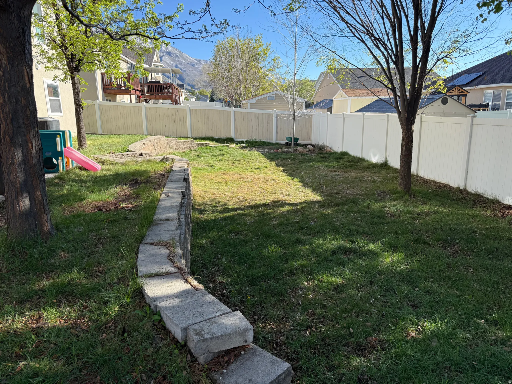 Fenced backyard with a residential view