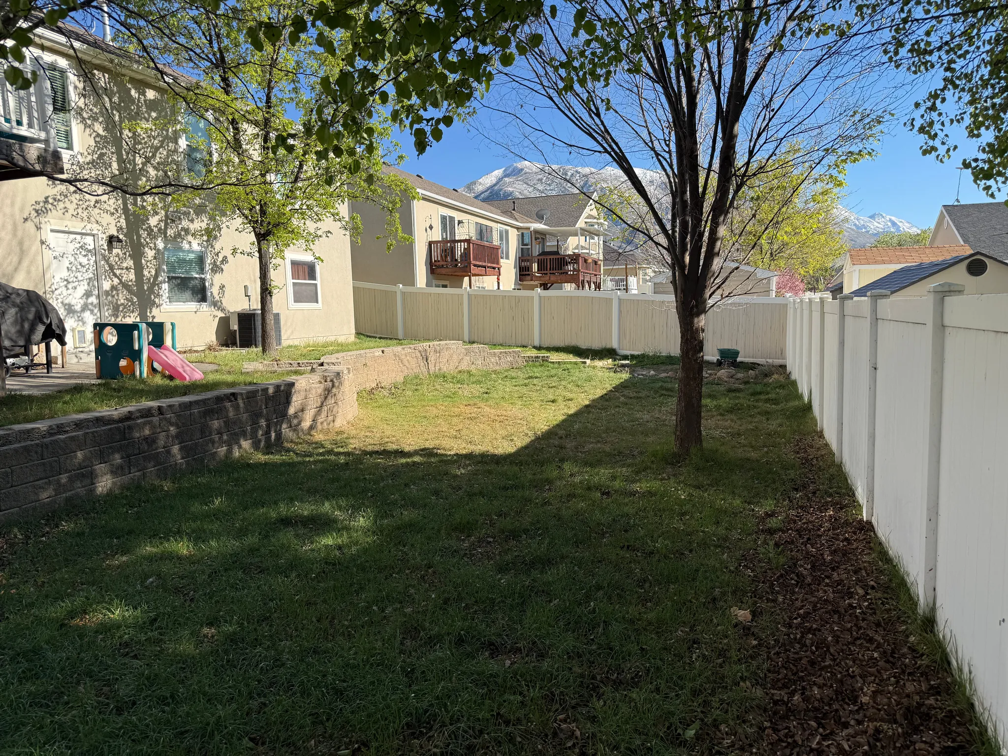 Fenced backyard with a residential view