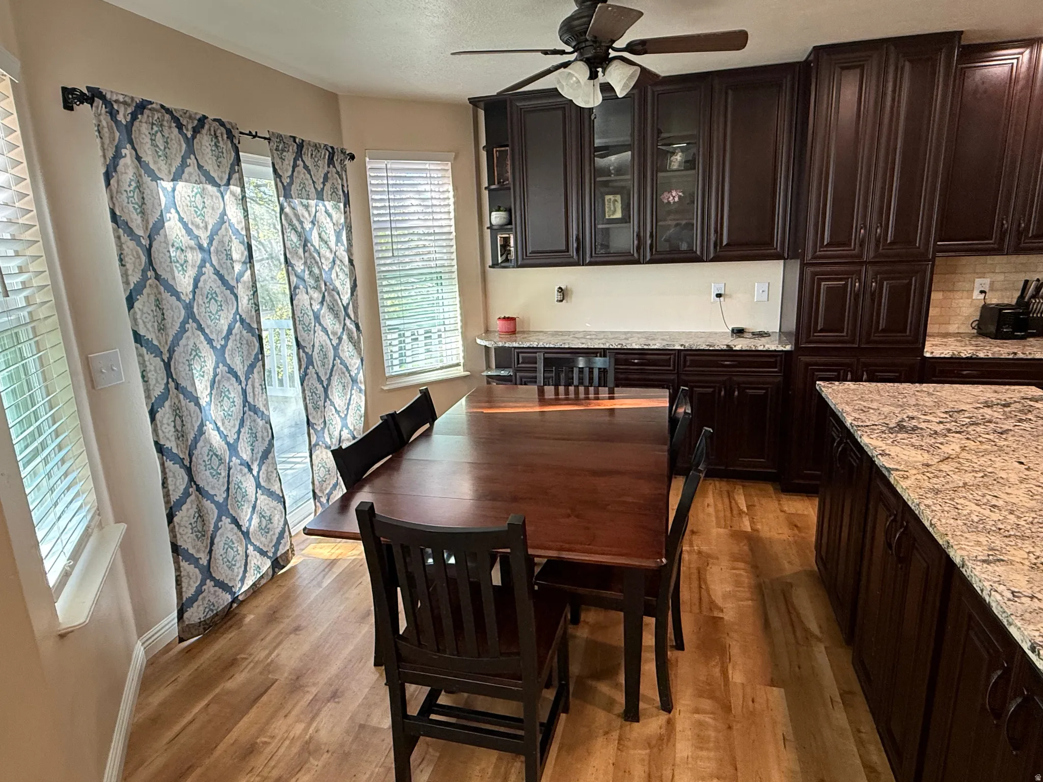 Dining room with ceiling fan and light wood-style flooring