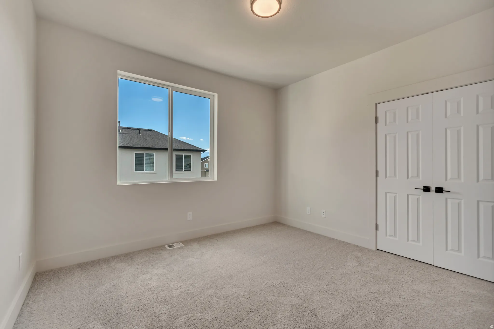 Unfurnished bedroom with carpet floors and a closet