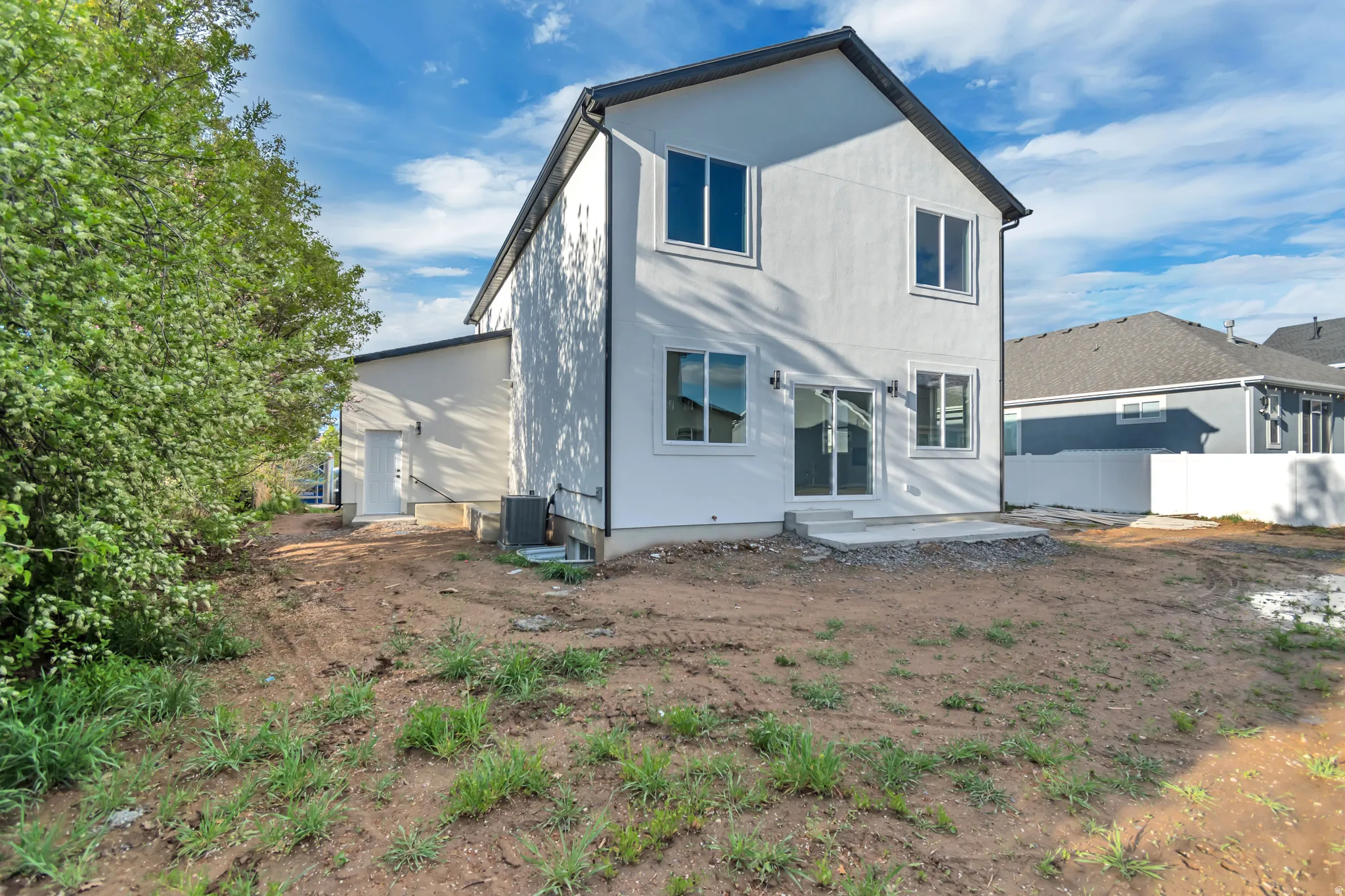 Rear view of house with a patio area and stucco siding