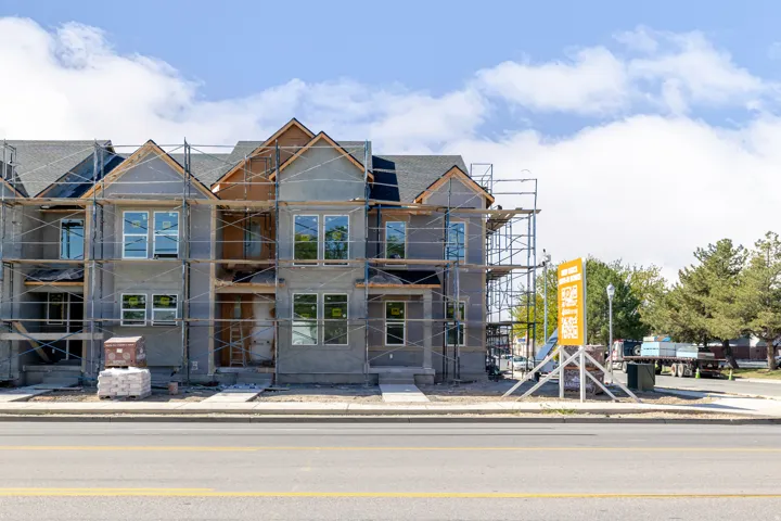 New construction townhome development featuring multiple gables and visible rooflines
