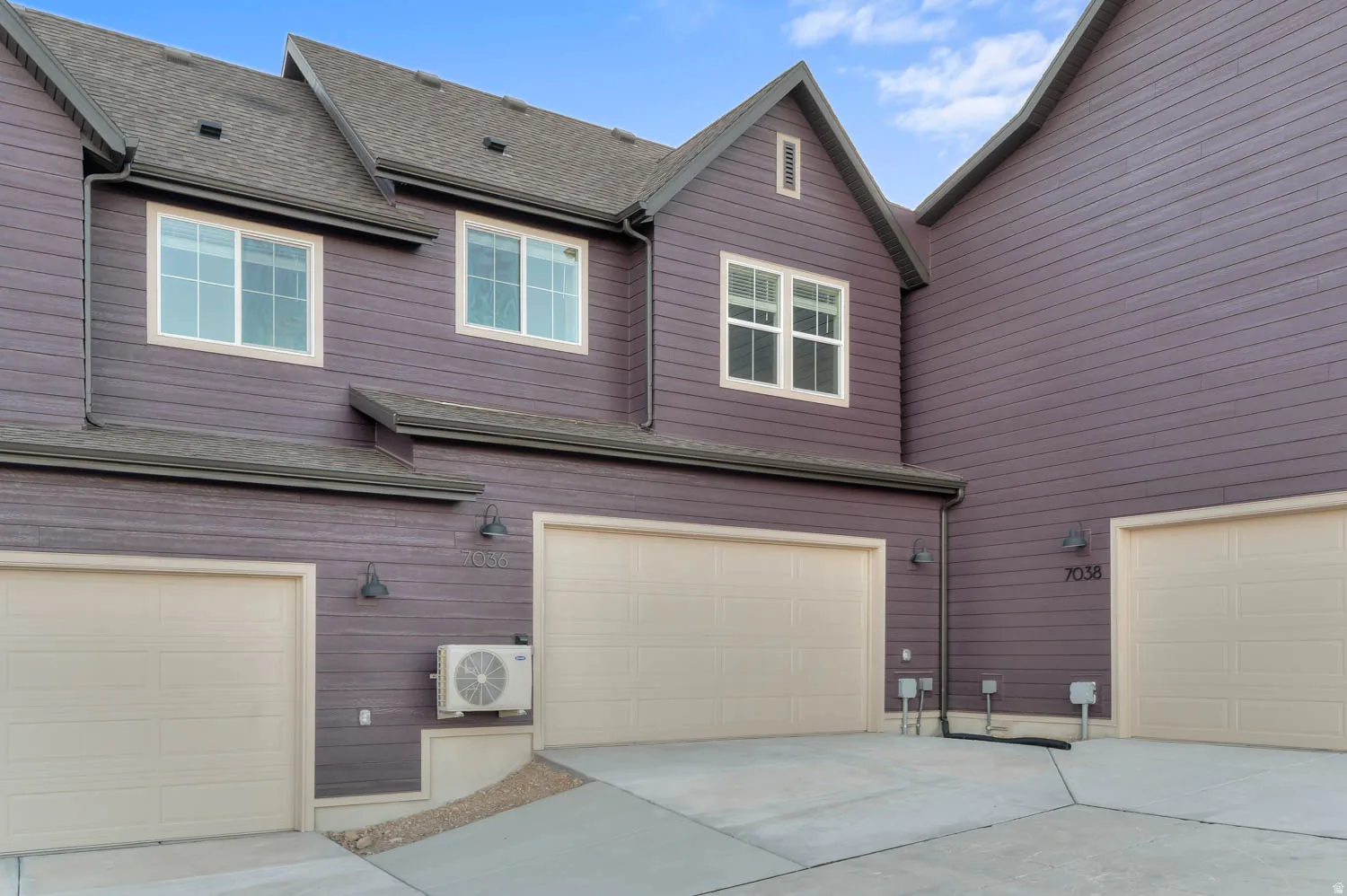 View of home's exterior featuring roof with shingles, concrete driveway, and an attached garage