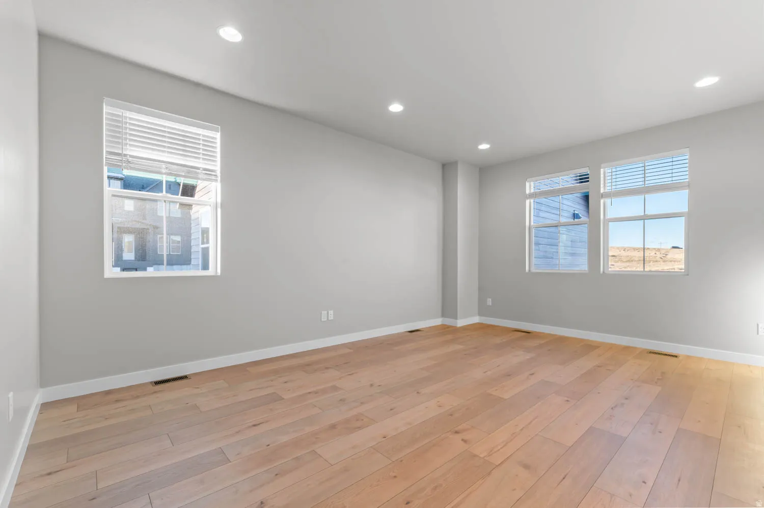 Empty room featuring light wood-style floors and recessed lighting