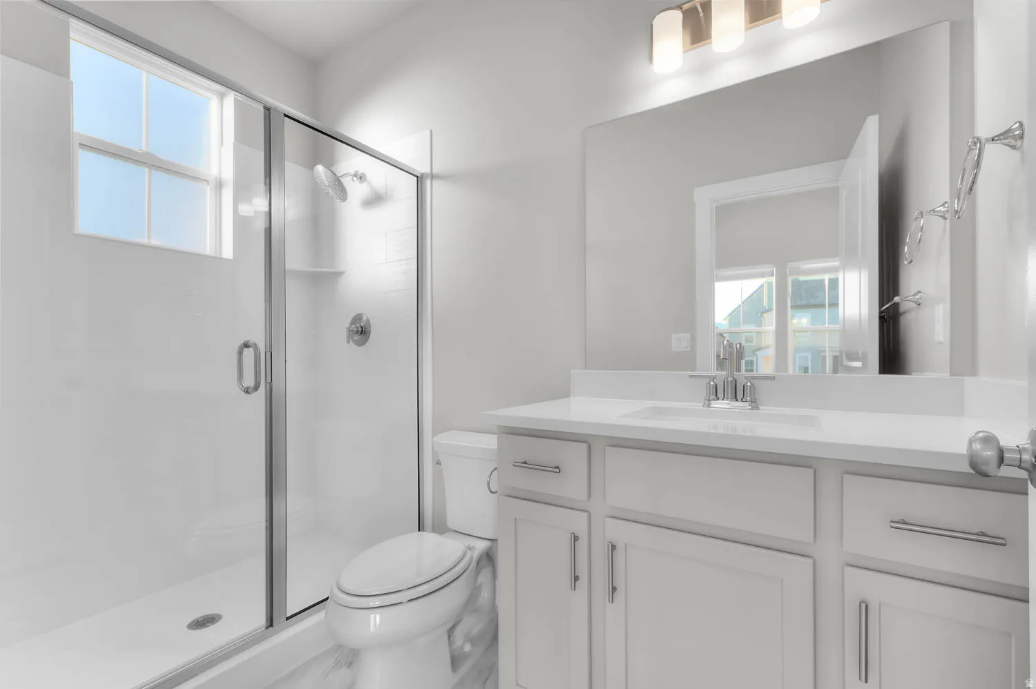 Full bathroom with healthy amount of natural light, vanity, and a stall shower