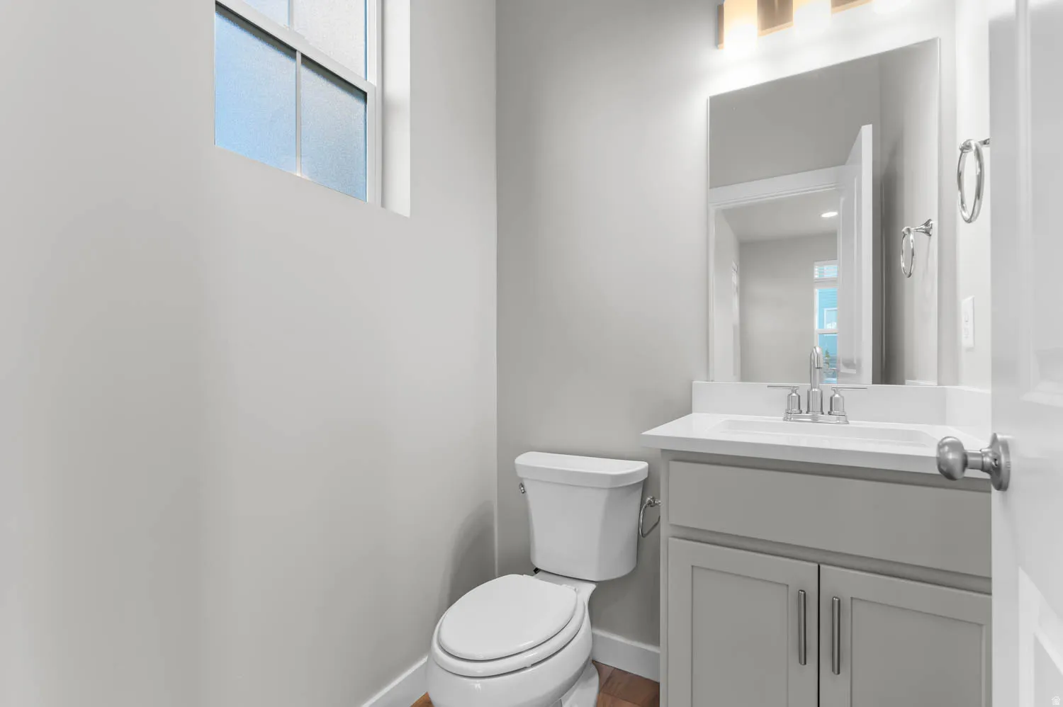 Half bathroom with vanity and toilet