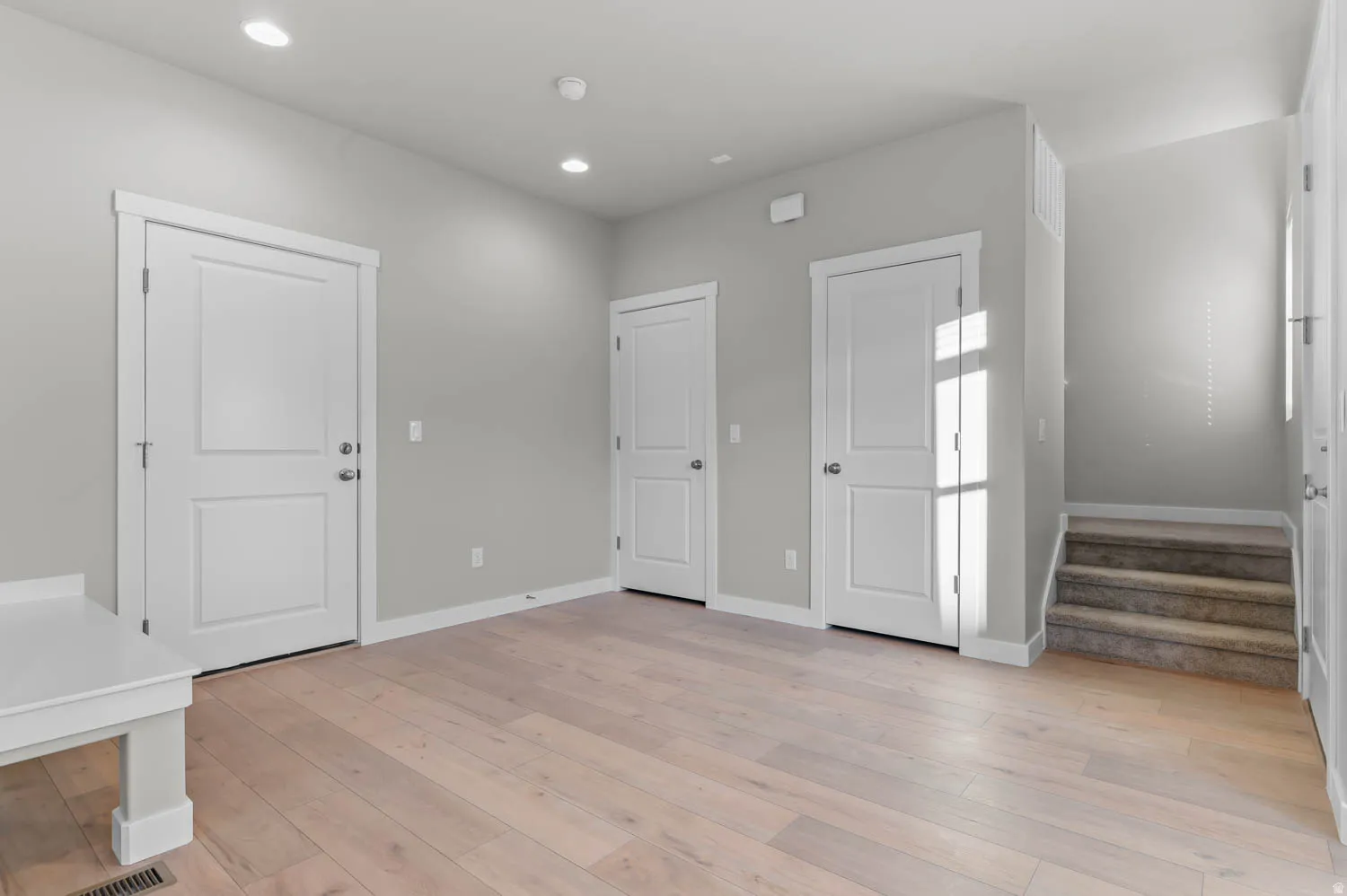 Entryway featuring light wood finished floors and recessed lighting