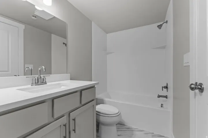 Bathroom with vanity and  shower combination