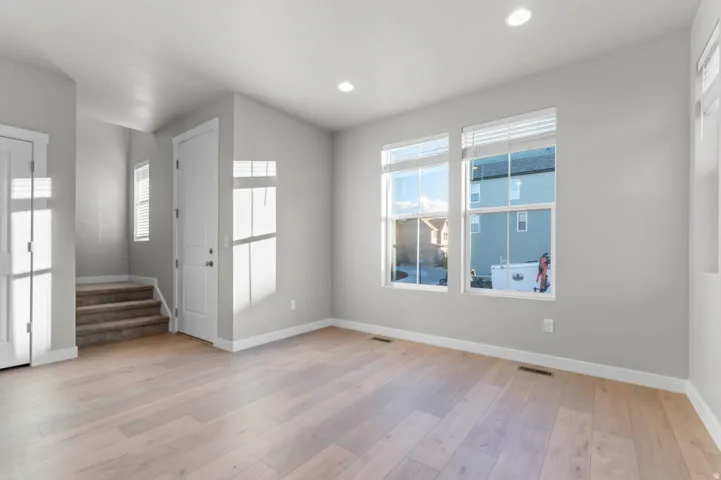 Foyer entrance with light wood-style flooring and recessed lighting