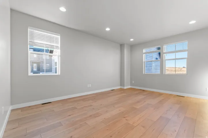 Empty room featuring light wood-style floors and recessed lighting