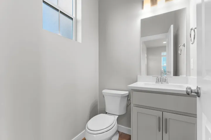 Half bathroom with vanity and toilet