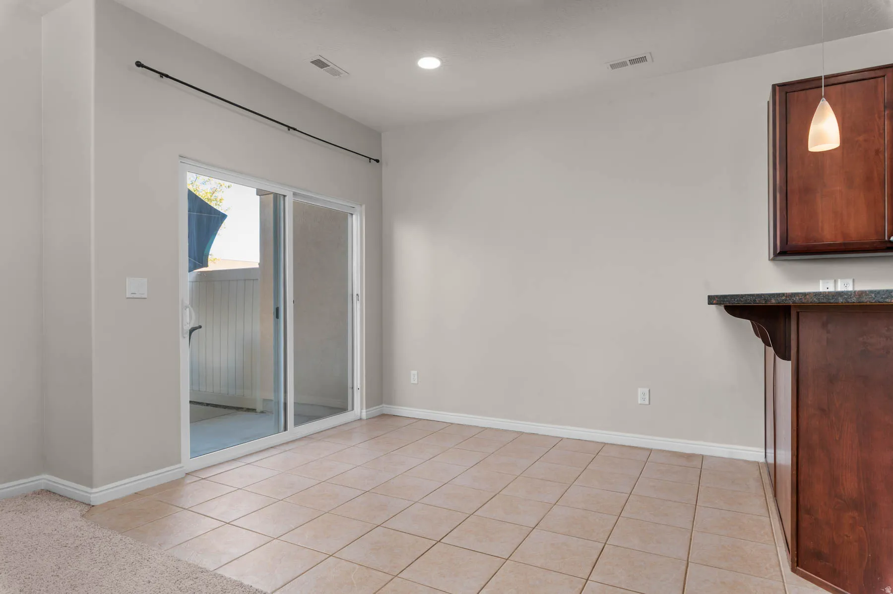 Unfurnished dining area featuring light tile patterned floors and recessed lighting