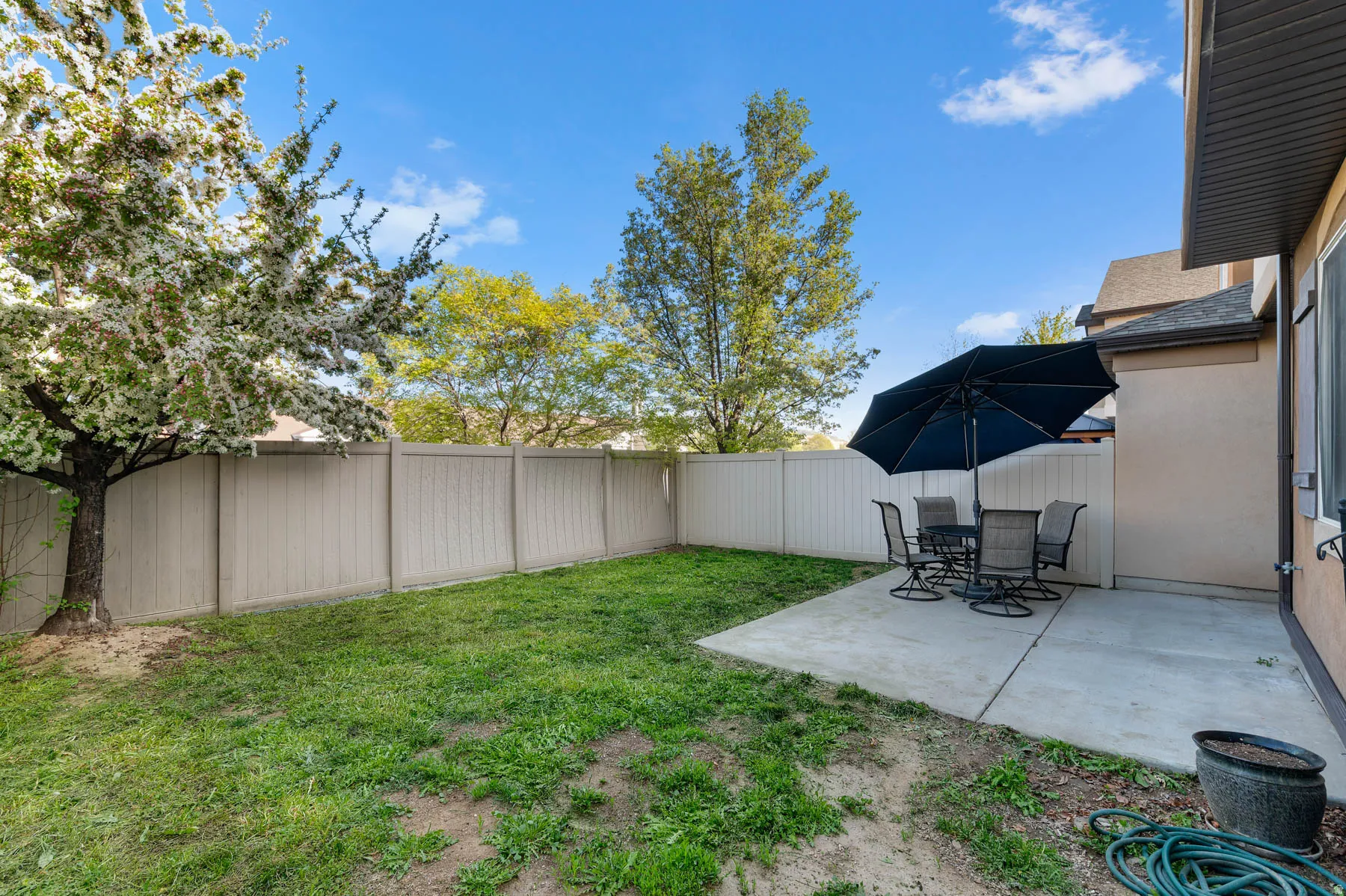 Fenced backyard with a patio and outdoor dining space