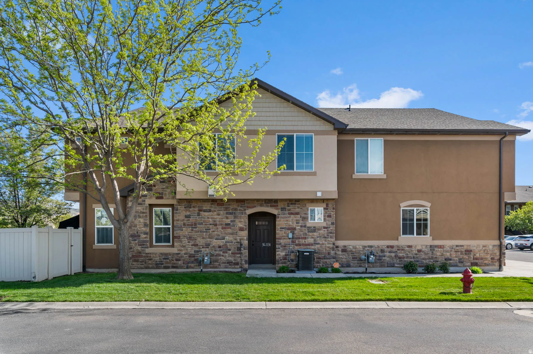 View of front of home featuring stone siding and stucco siding