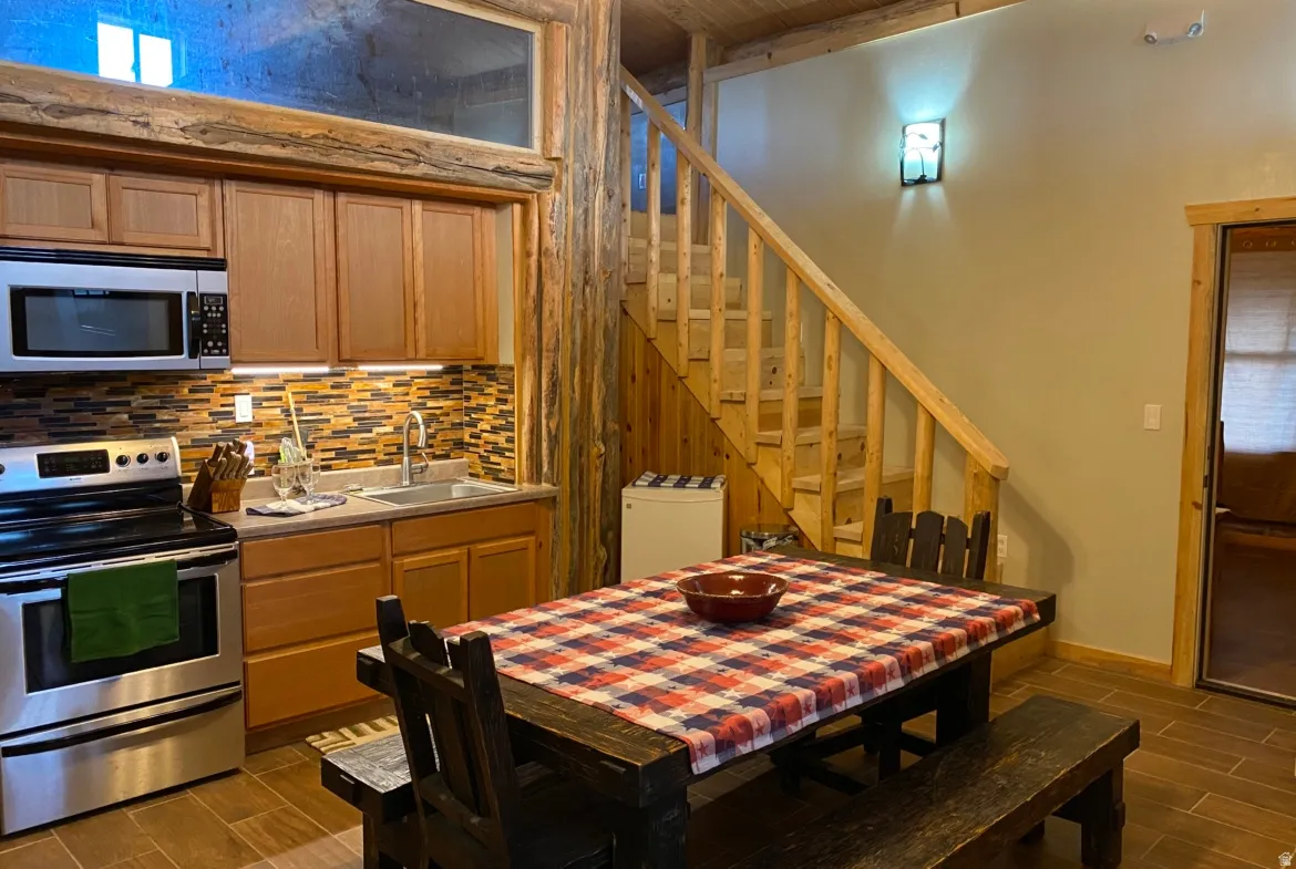 Dining space with wood finish floors and stairway