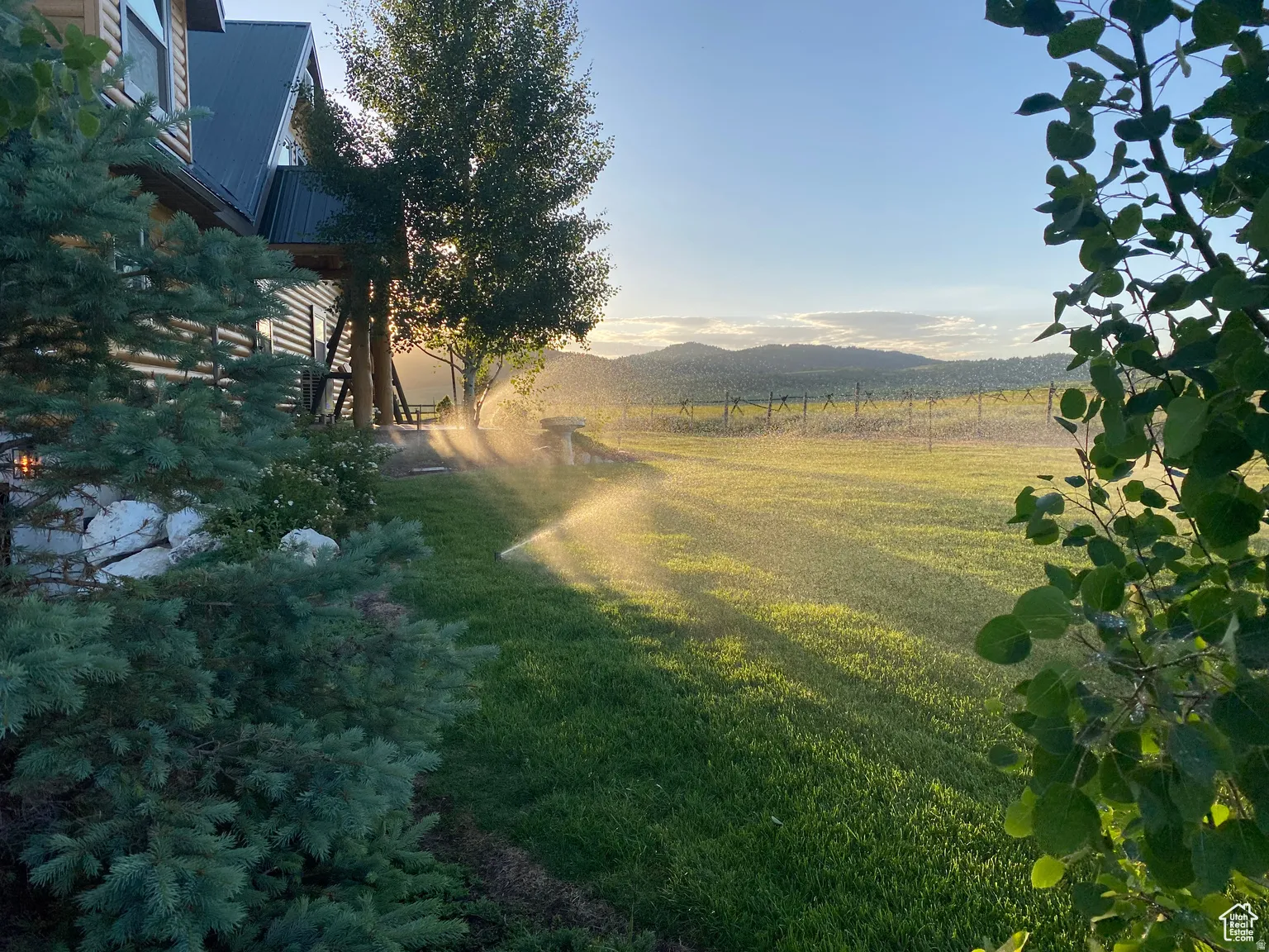 View of grassy yard featuring a mountain view and a view of countryside