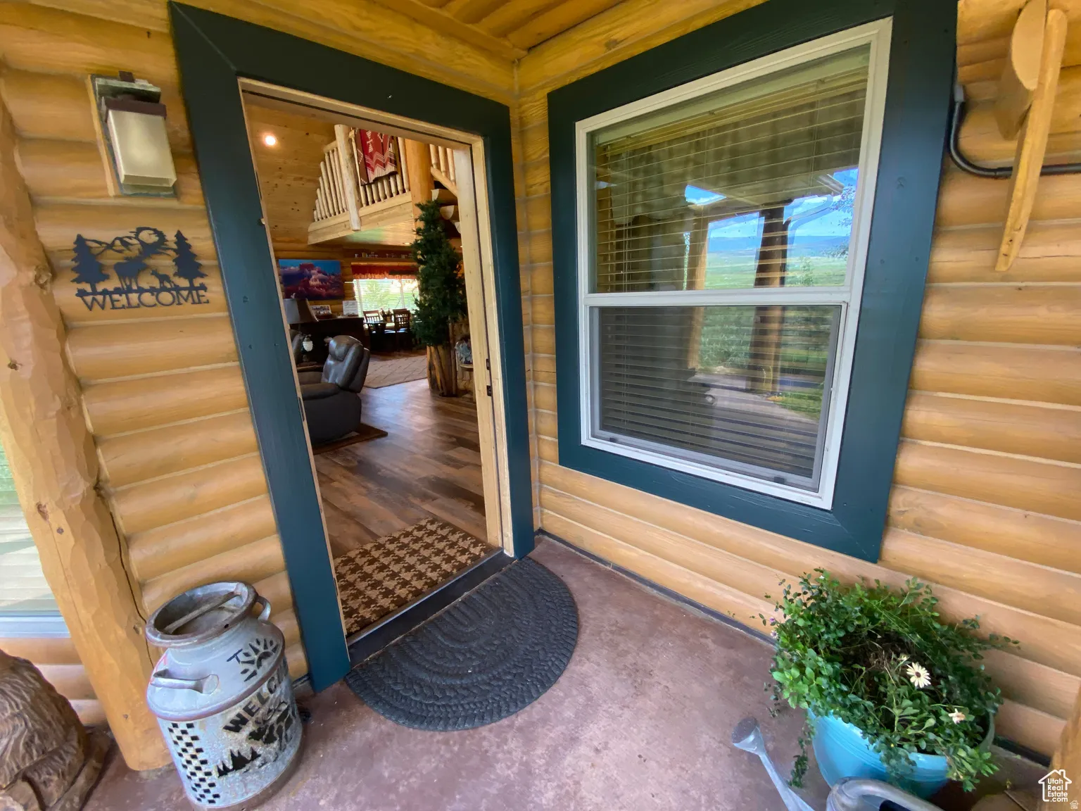 Property entrance with faux log siding