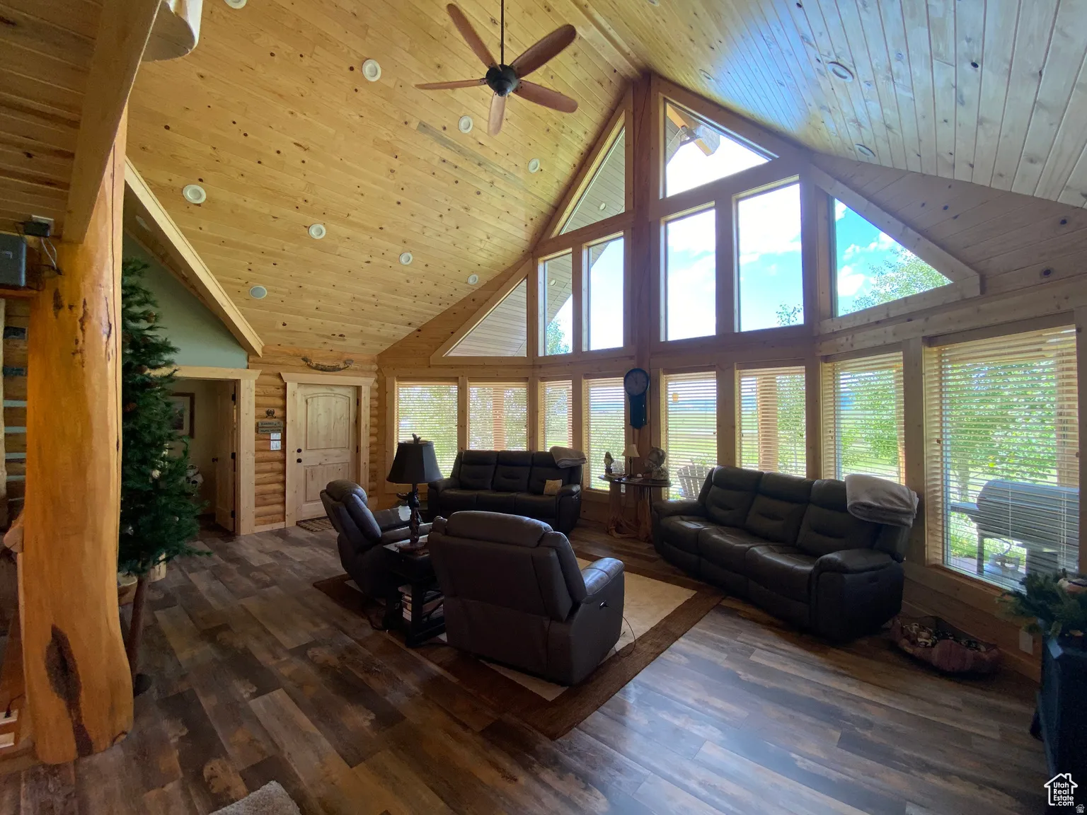 Living area with a high wood ceiling, hardwood / wood-style flooring, and ceiling fan