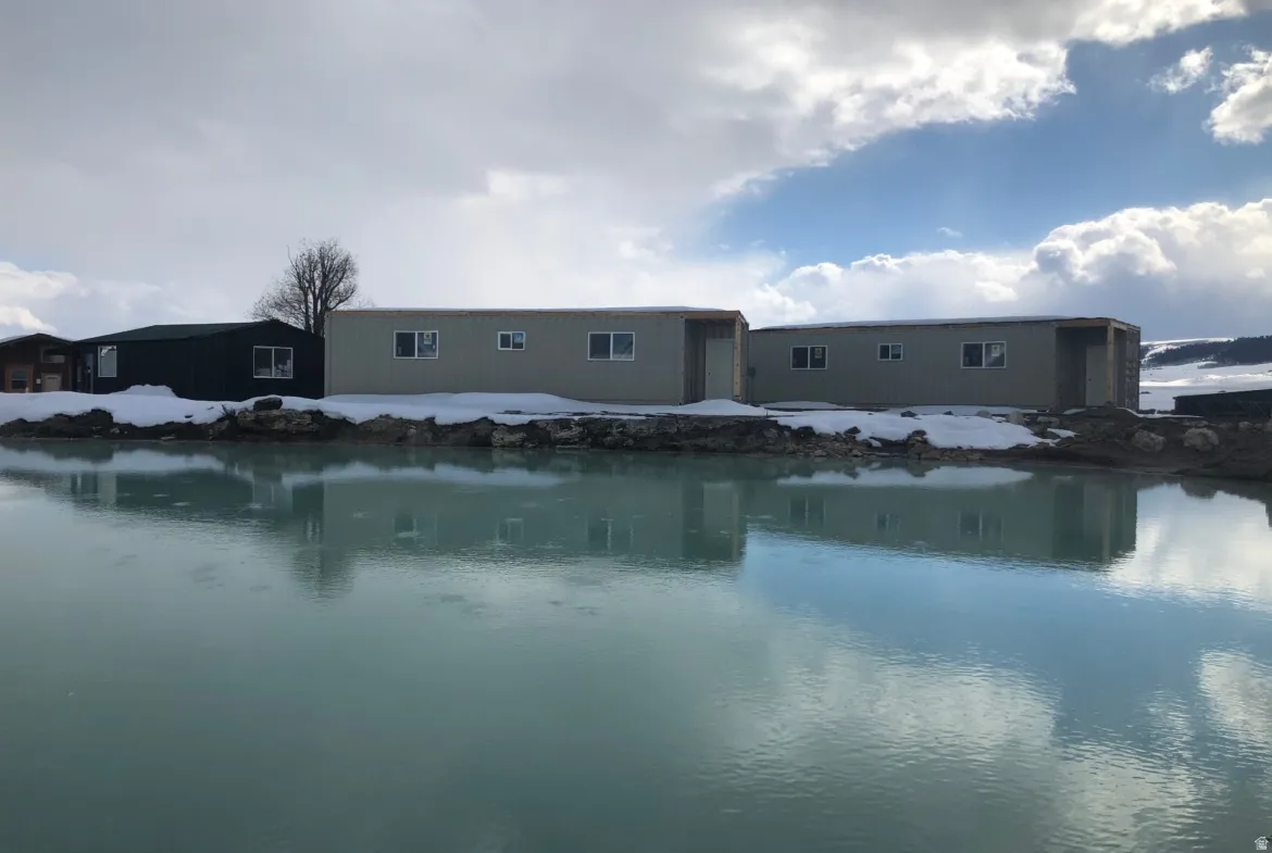 Back of house featuring a water view