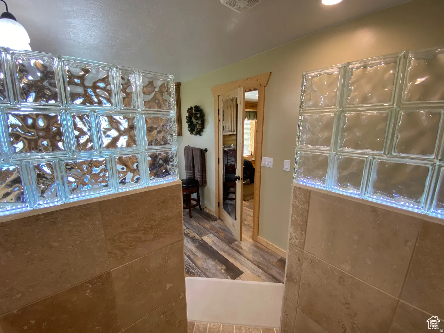 Full bath featuring dark wood-style flooring