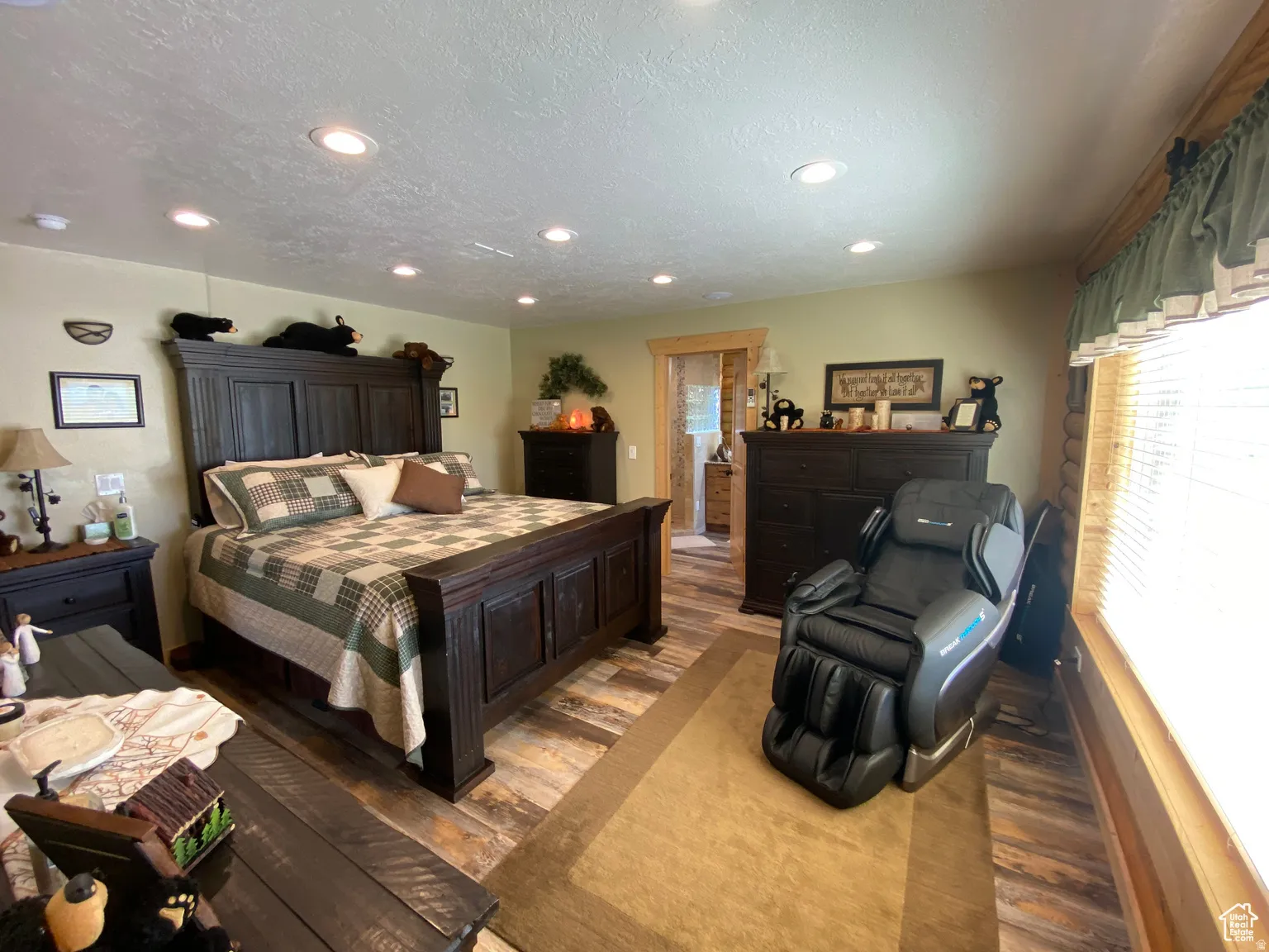 Bedroom with dark wood-style floors, a textured ceiling, and recessed lighting