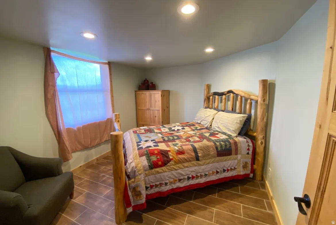 Bedroom with recessed lighting and wood tiled floors