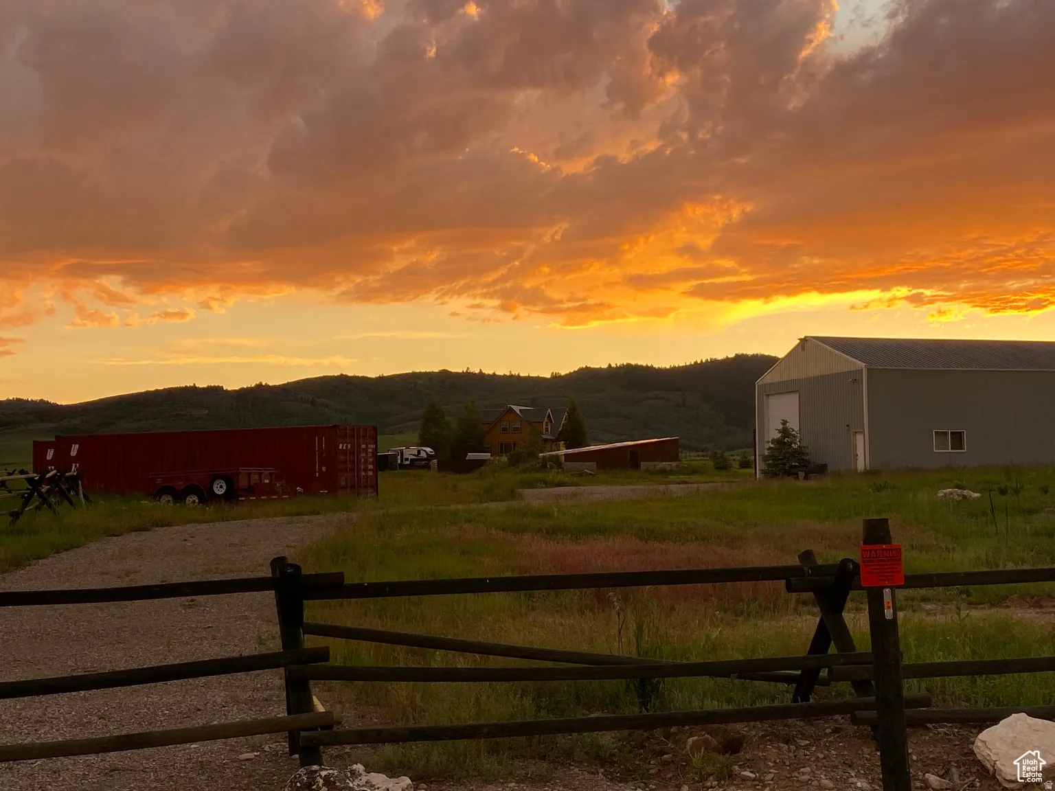 View of yard featuring a mountain view, a rural view, an outbuilding, and a garage