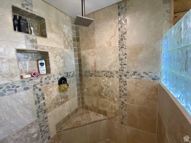 Full bath with a tile shower