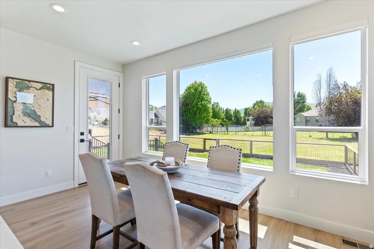 Dining area featuring light wood finished floors and recessed lighting