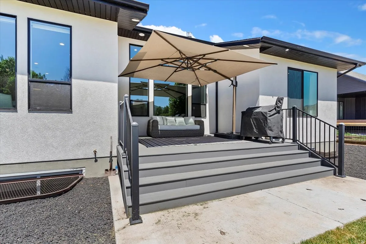 Deck with outdoor furniture, a patio, and a grill