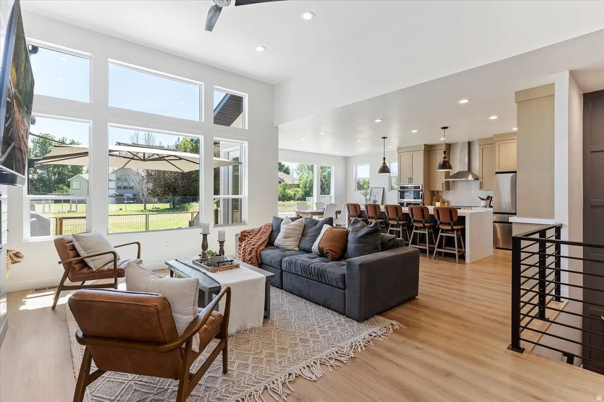 Living room with recessed lighting and light wood-type flooring