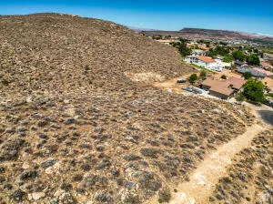 Aerial view of sparsely populated area with mountains and a desert landscape