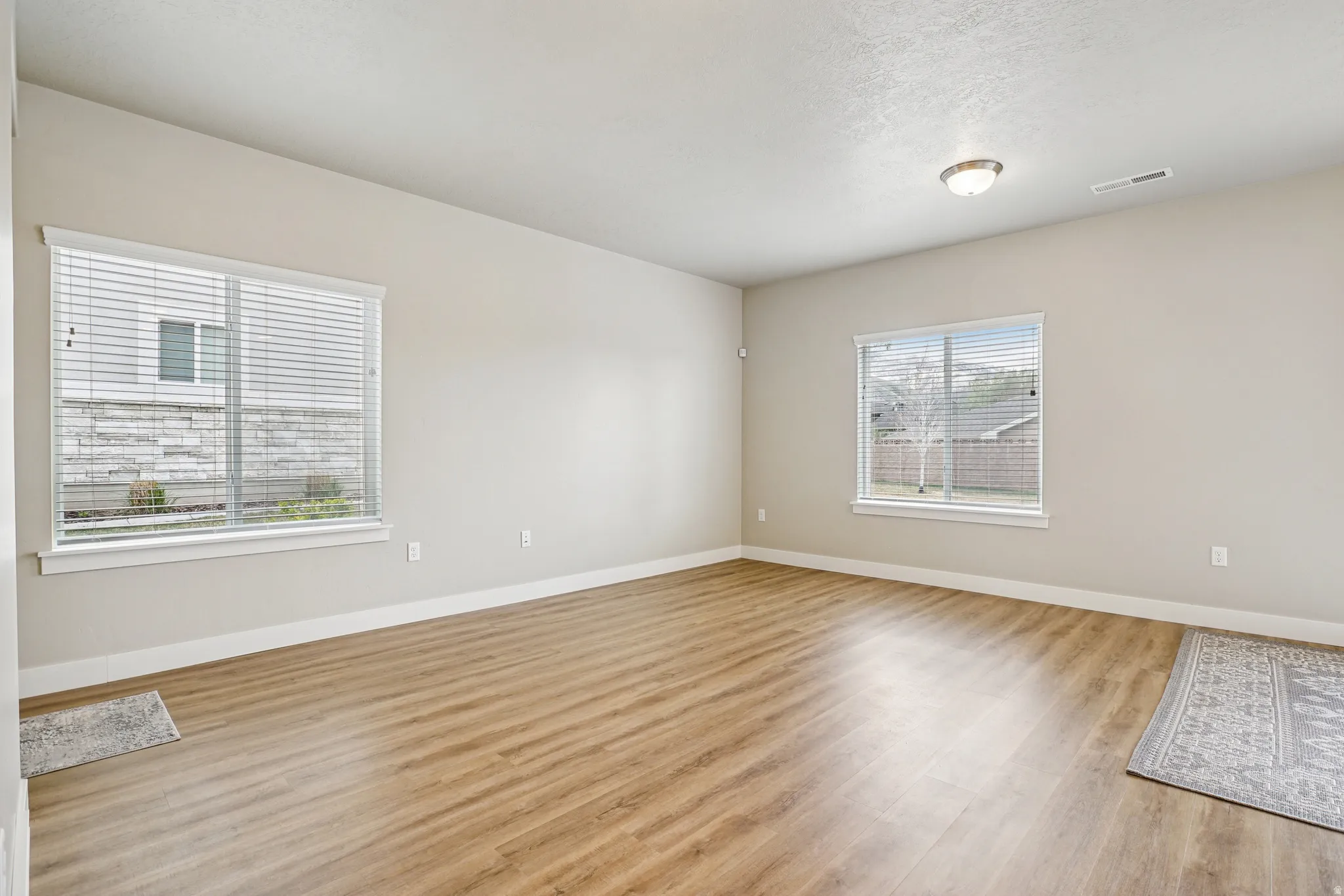 Unfurnished room with light wood-type flooring and baseboards