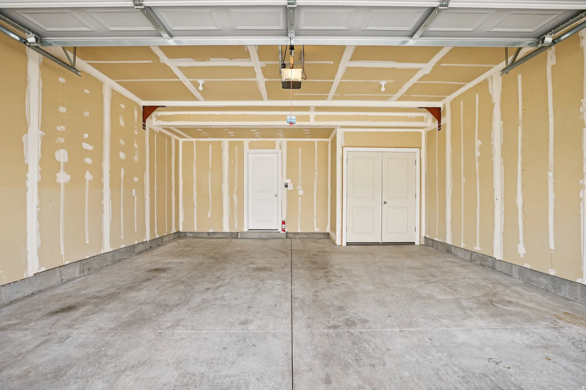 Garage featuring a garage door opener