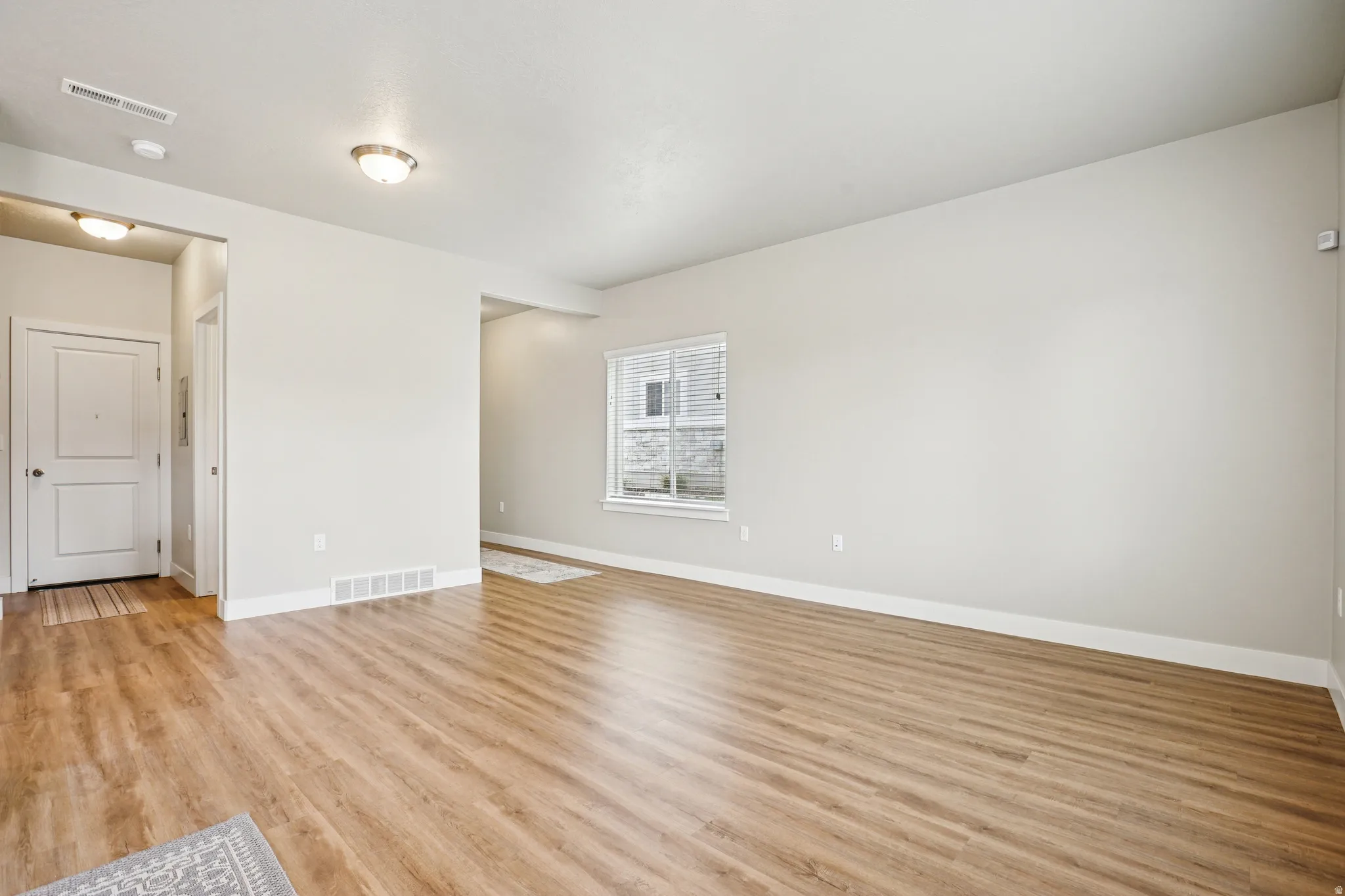 Unfurnished room featuring light wood-type flooring and baseboards