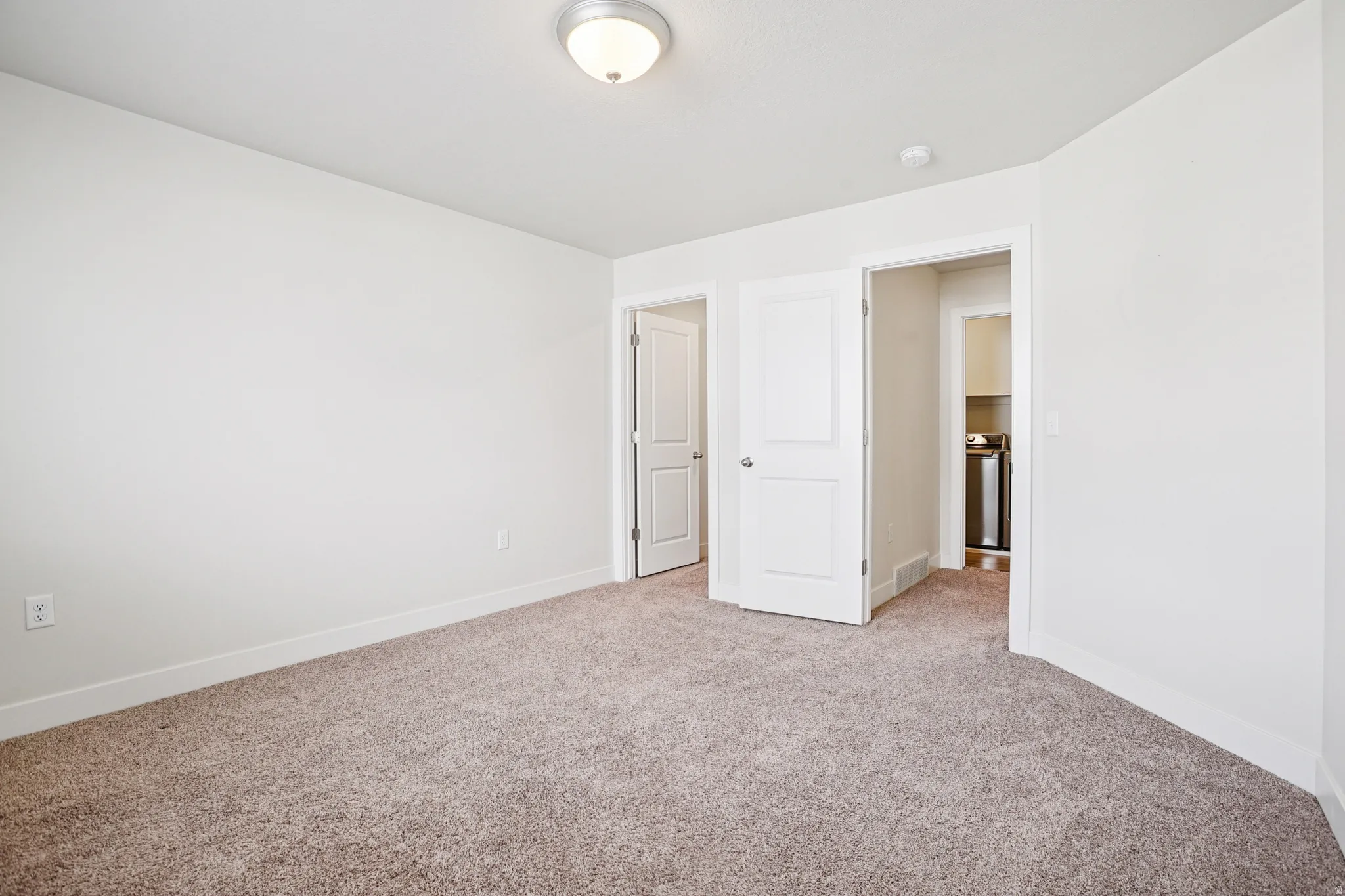Unfurnished bedroom featuring carpet and baseboards