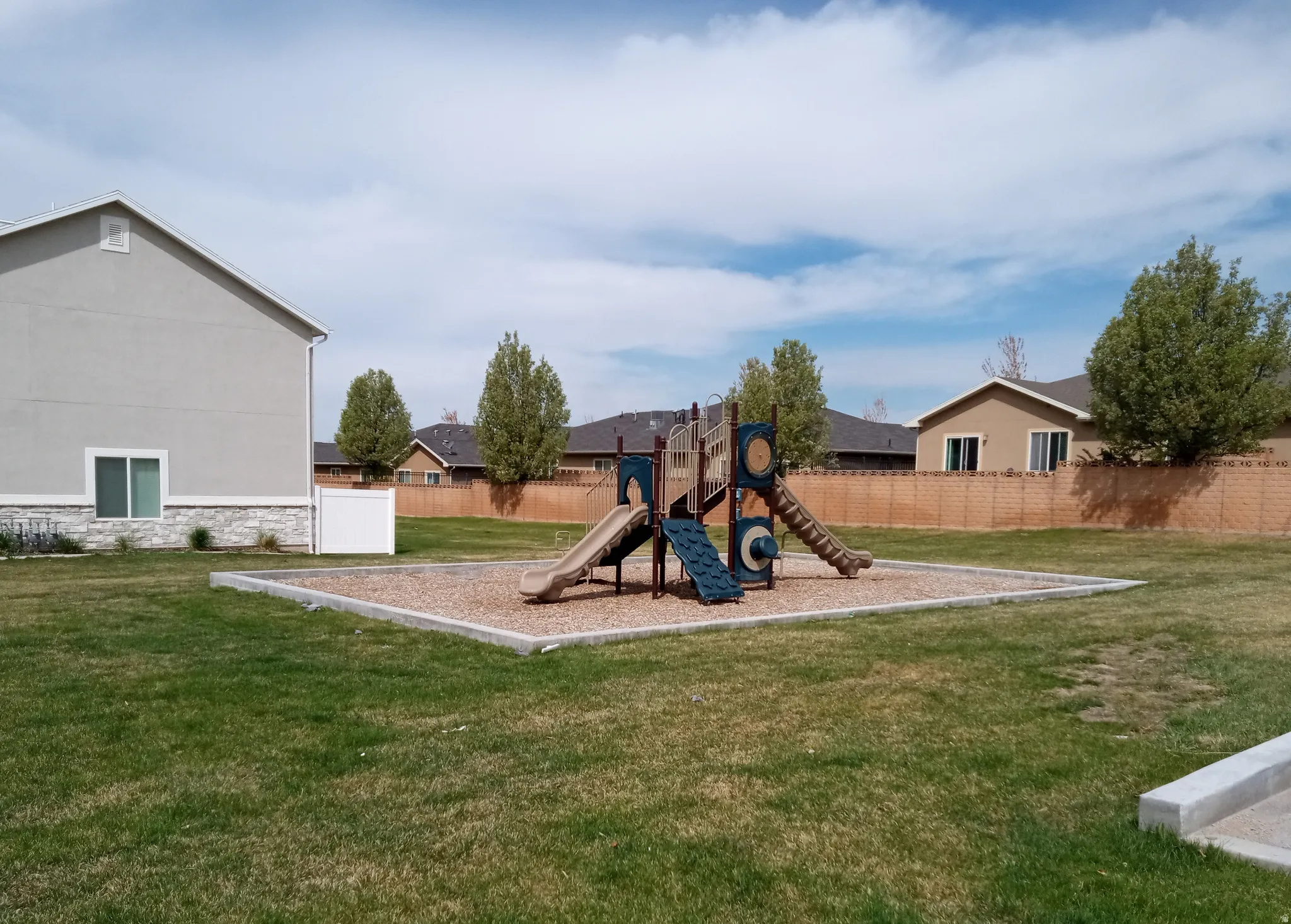 Community playground featuring a yard